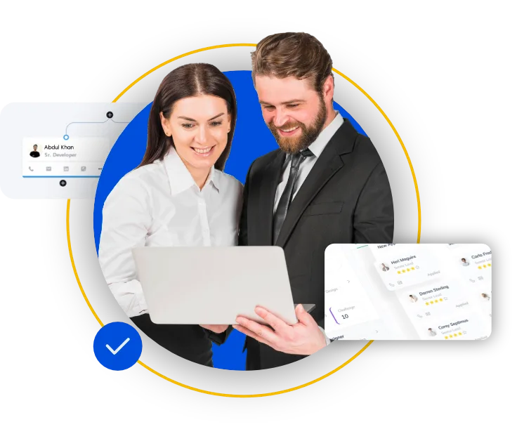 Two smiling HR professionals, a woman and a man, collaboratively viewing an employee profile and a list of applicants on a laptop screen.