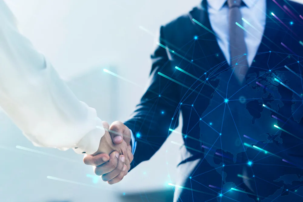 Two business professionals shaking hands, with a global network overlay in the background symbolizing connection and trust.
