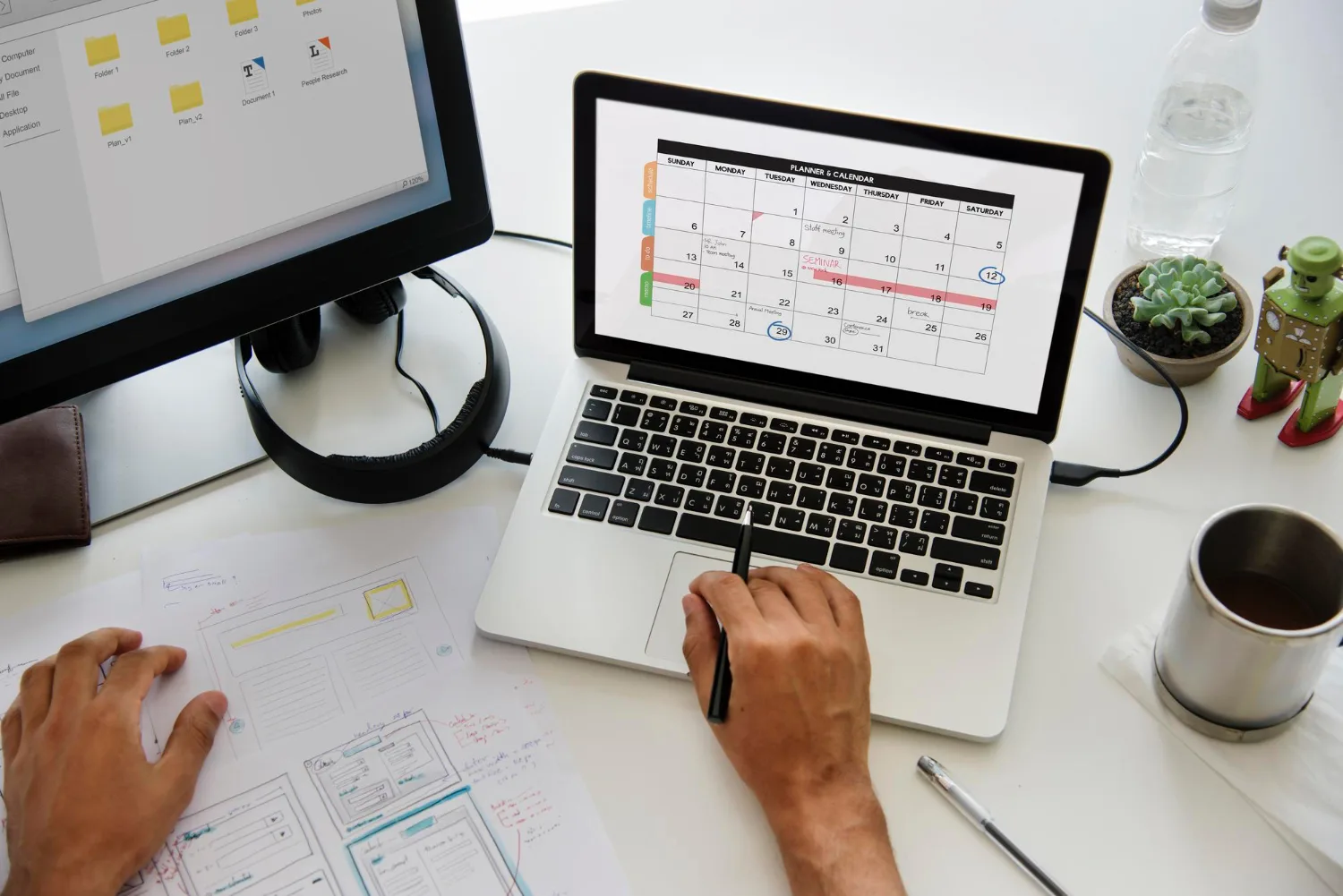 Close-up of hands scheduling interviews using a digital calendar on a laptop - Efficient Interview Scheduling