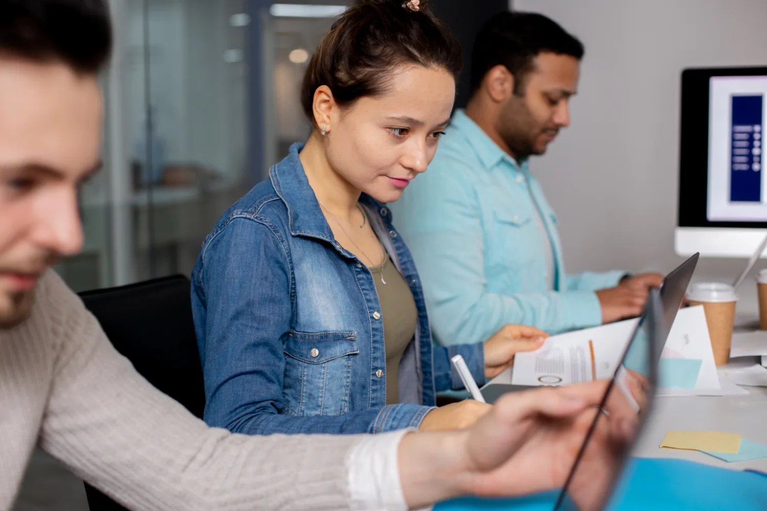 Team members reviewing synchronized attendance data on a laptop