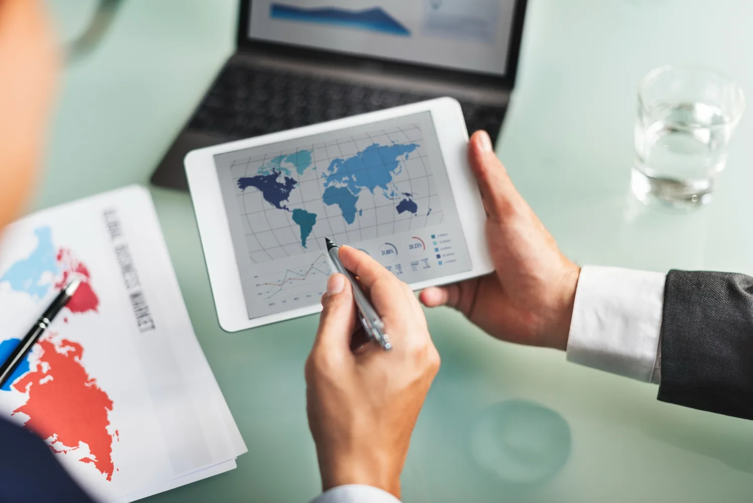 Businessman analyzing a global compliance map for international payroll